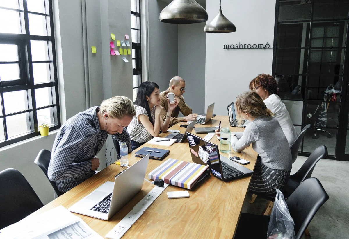A team collaborating around a shared work table